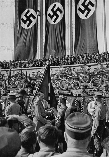 Adolf Hitler dedicates new standards, Nuremberg Rally, Germany, 1934. Artist: Unknown