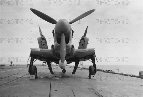 Fairey Firefly aircraft ready to be transported to the hangar lift, HMS 'Venerable', 1945. Artist: Unknown