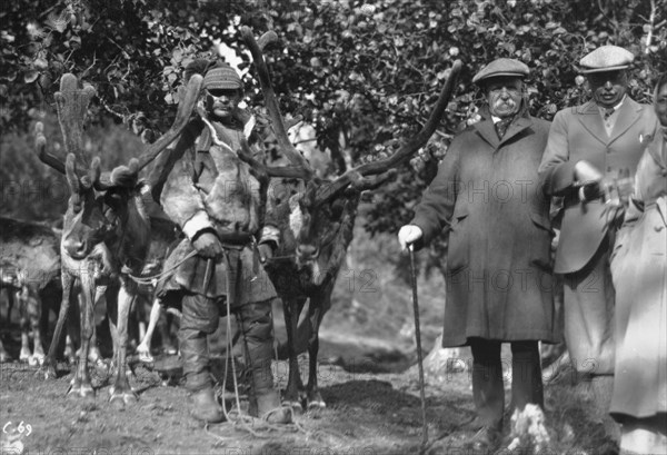 Tourists posing alongside a man with reindeer, Lyngen, Norway, 1929. Artist: Unknown