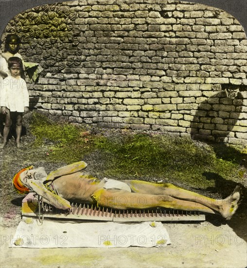 Hindu devotee on a bed of nails near the shrine of Kali, Calcutta, India, early 20th century(?). Artist: Underwood & Underwood