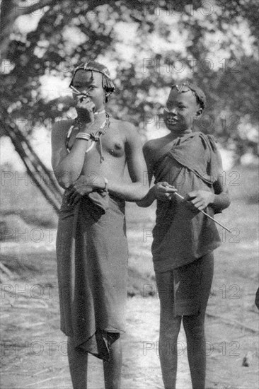 Young girls with sticks in their noses and lips, Terrakekka to Aweil, Sudan, 1925 (1927). Artist: Thomas A Glover