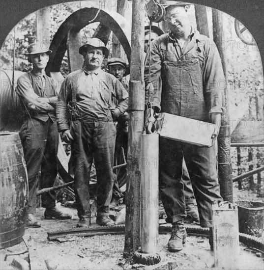 Filling a shell with nitro-glycerine, oil field in Pennsylvania, USA, early 20th century(?). Artist: Keystone View Company