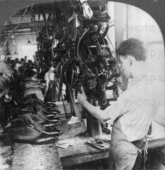 Lasting machine shaping shoes in shoe factory, Lynn, Massachusetts, USA, early 20th century(?). Artist: Keystone View Company