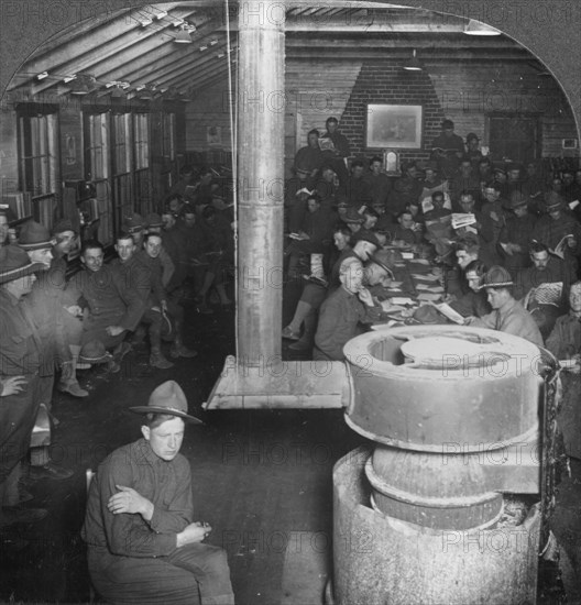 Social room of a YMCA army camp hut, early 20th century. Artist: Keystone View Company