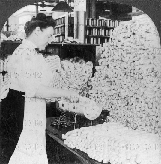 Weighing and sorting raw silk skeins, South Manchester, Connecticut, USA, early 20th century. Artist: Keystone View Company