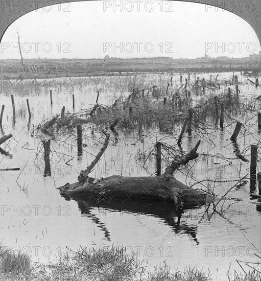 Opened sluices and barbed wire at Nieuwpoort, Belgium, World War I, c1914-c1918. Artist: Realistic Travels Publishers