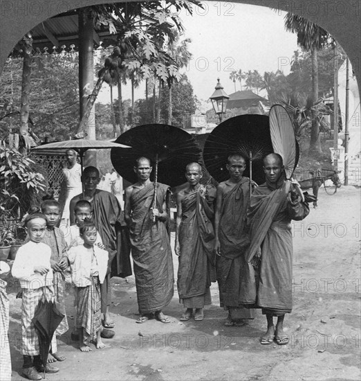 Buddhist monks with sunshades and fans, Rangoon, Burma, 1908. Artist: Stereo Travel Co
