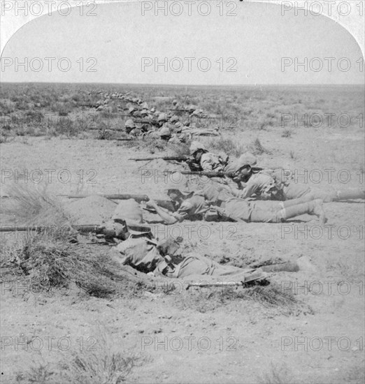 Wiltshire boys stealing on the enemy at the Orange River, South Africa, 2nd Boer War, 1900.  Artist: Underwood & Underwood