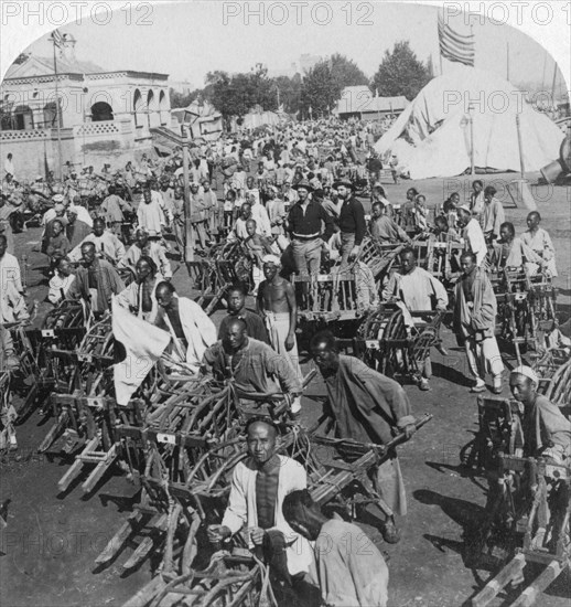 'Wheelbarrow transportation at the boat landing', Tientsin (Tianjin), China, 1901. Artist: Underwood & Underwood