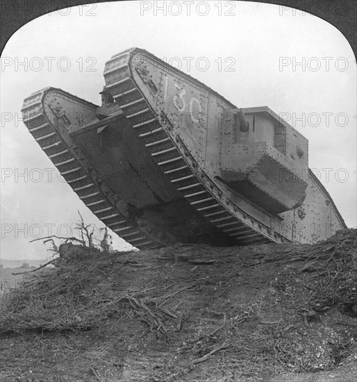 'A tank breaking through the wire at Cambrai', France, World War I, c1917-c1918. Artist: Realistic Travels Publishers