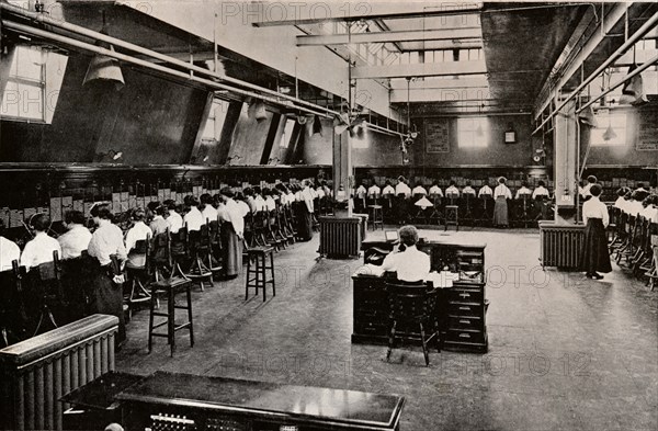 In a Large Telephone Exchange, c1916. Artist: Unknown.