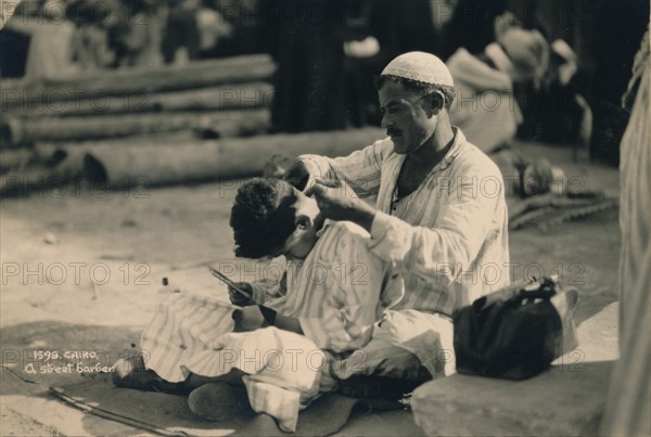 A Street Barber, Cairo, Egypt, 1936. Artist: Unknown