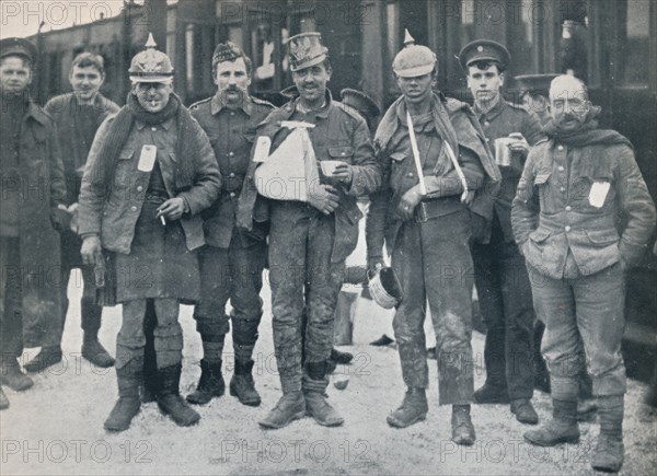 Some cheerful wounded from the Neuve Chapelle fighting, wearing captured German helmets, 1915. Artist: Unknown