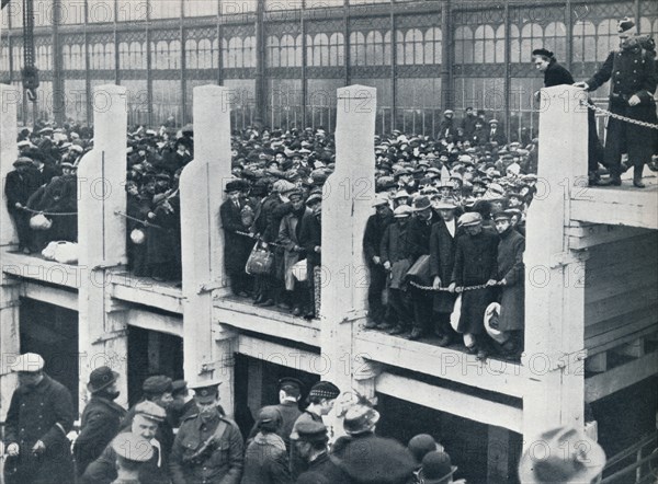 Belgian refugees on the harbour at Ostend waiting for a boat to take them to England, 1914.