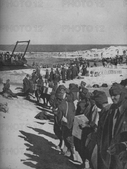 Italian prisoners captured by the British assisting in the loading of a store ship, 1941. Artist: Unknown.