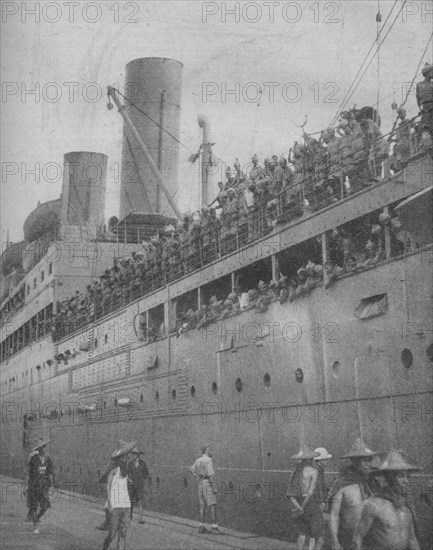 'At Singapore Indian troops arrive to take part in the defence of the great fortress-port.', 1941.  Artist: Unknown.