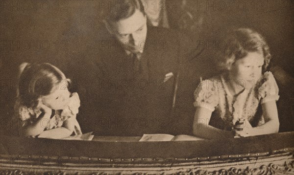 The Duke of York and Princesses Elizabeth and Margaret at the pantomime, 6 February 1935.  Artist: Unknown.