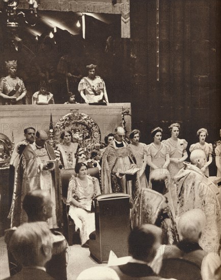 'Queen Elizabeth looks on as her husband is crowned on the day of his coronation', 1937. Creator: Unknown.