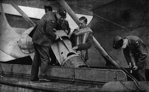 Loading bombs on to an RAF aircraft during World War II, c1940 (1943). Artist: Unknown.