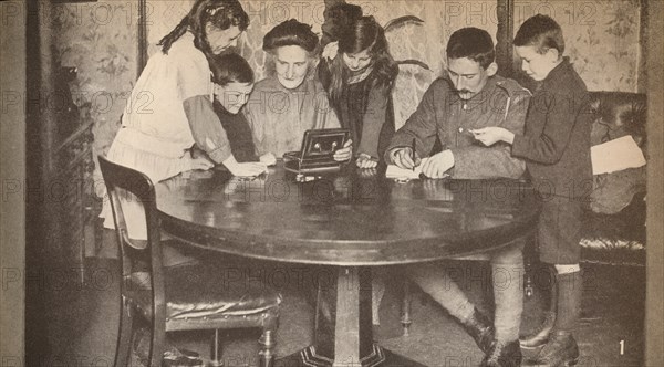 'Children emptying their money-boxes to invest in war loan', c1917, (1935). Artist: Unknown.