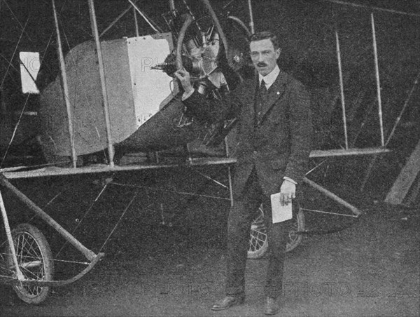 One of the best instructors: Lewis WF Turner standing by a Caudron training biplane, 1913 (1934). Artist: Flight Photo.