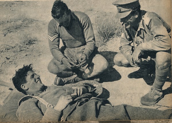 'Ambulance men with a wounded anti-tank gunner', c1942 (1944). Artist: Unknown.