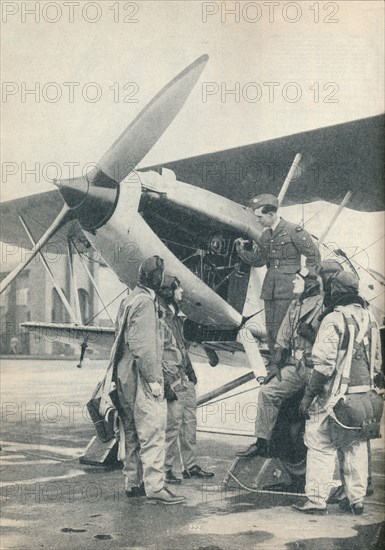 An instructor explaining engine details to a pupils at Sealand Aerodrome, Flintshire, c1936 (c1937). Artist: Unknown.