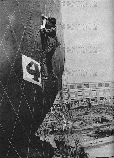 Making adjustments to the net of a balloon before attaching the basket, c1935 (c1937). Artist: Unknown.