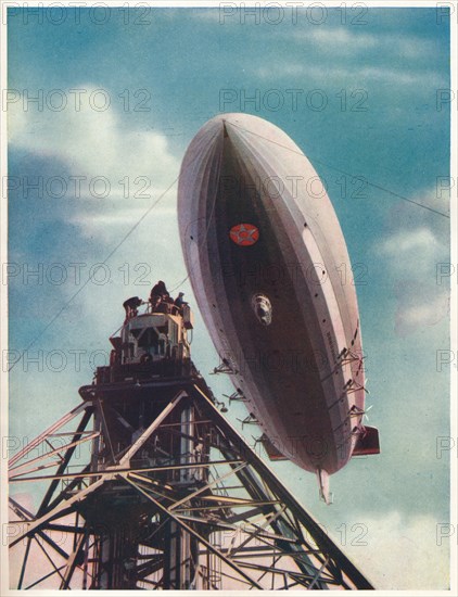 The US airship 'Macon' being moored to the mobile mast at Lakehurst, New Jersey, c1935 (c1937). Artist: Unknown.