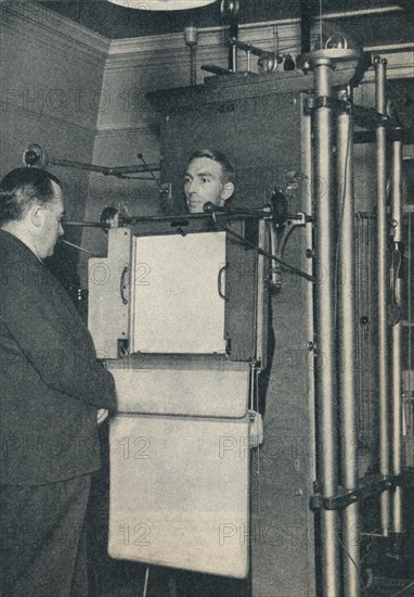 X-ray apparatus used for examination of suspected cases of heart or lung disease, c1935 (c1937). Artist: Unknown.