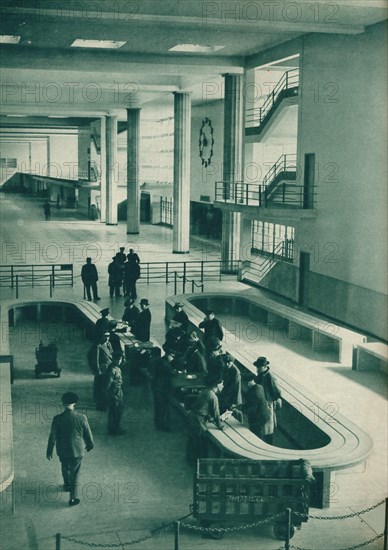 Customs officers examining passengers' baggage at Le Bourget Airport, Paris, 1937. Artist: Unknown.