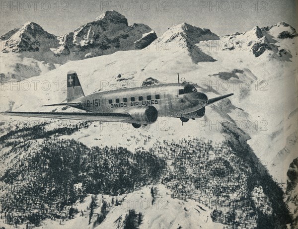 A Swissair plane flying near St Moritz Aerodrome, Switzerland, c1936 (c1937). Artist: Unknown.