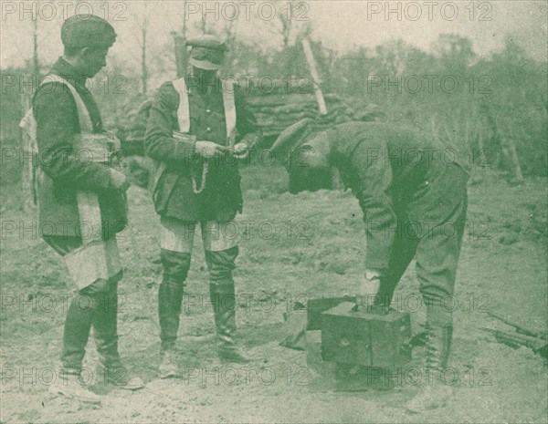 Aerial photographers fixing on parachute harnesses before making an ascent, c1917 (1919). Artist: Unknown.