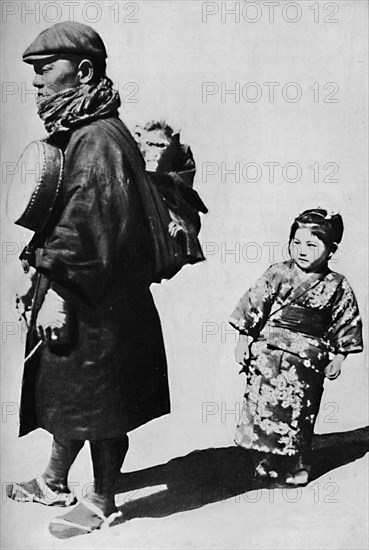 ''With his drum and monkey he is Japan's equivalent to our old-style organ grinder', c1900, (1921).  Artist: Julian Leonard Street.