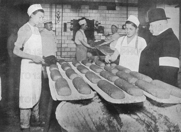 'An inspector visiting a Berlin bakery', 1915.  Artist: Unknown.