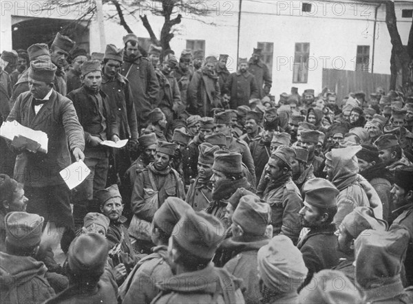 'Issuing passes for a few days leave at home to the wounded Serbian troops at Nish', 1915. Artist: Unknown.