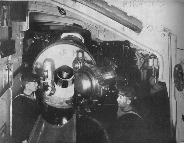 'Inside the Barbette of a Battleship showing the opened breech of a 13'5 inch gun', 1914. Artist: Unknown.