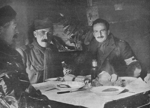 'Red Cross officers at dinner in a dug-out', 1914. Artist: Unknown.
