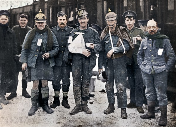 Some cheerful wounded from the Neuve Chapelle fighting, wearing captured German helmets, 1915. Artist: Unknown.