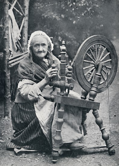 An old Irish woman at her spinning-wheel, 1912. Artist: W Lawrence.