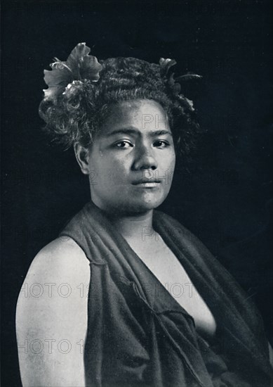 A Tongan woman, with scarlet hibiscus blossoms in her hair, 1902. Artist: JJ Lister.