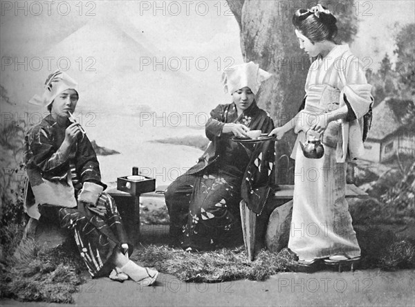 Japanese peasant girls taking tea at a wayside rest, 1902. Artist: Unknown.