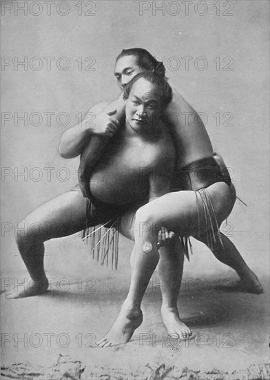 A sumo wrestling bout between a pair of Japanese professionals, 1902. Artist: Unknown.