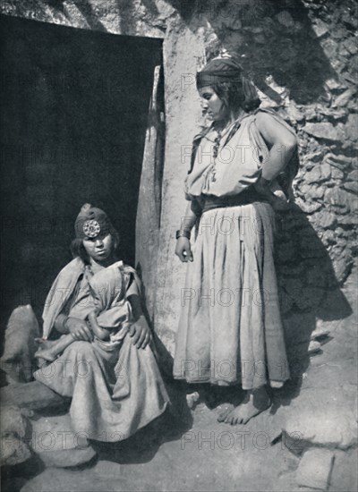 Kabyle women at the door of their dwelling near the Mediterranean coast, Algeria, 1912.. Artist: Kuhn.
