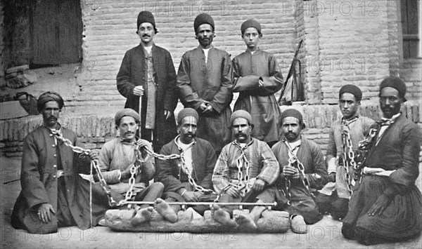 Prisoners and gaolers in a prison yard, Nahavand, Persia, 1902. Artist: Unknown.