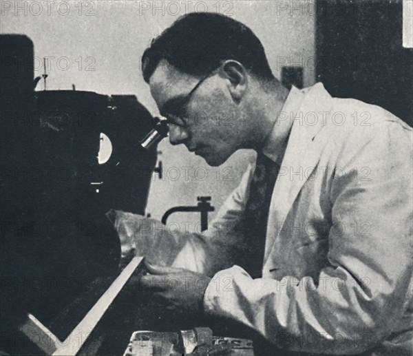 'Research worker with microscope (testing the structure of an aluminium alloy)', 1941. Artist: Cecil Beaton.