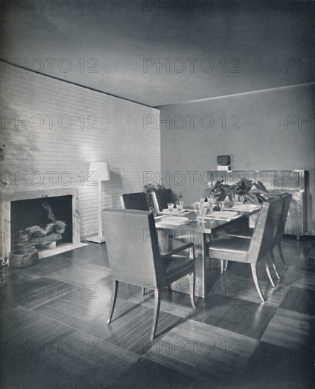 'Dining-room furniture with leather-upholstered chairs designed by T. H. Robsjohn-Gibbings and made Artist: Unknown.