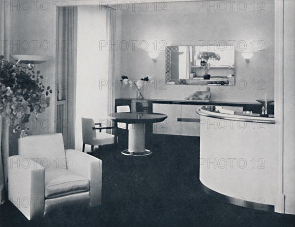 'Jacques Adnet - Bar corner of a dining-room. The furniture is in polished black pearwood, black gla Artist: A. Salaun.