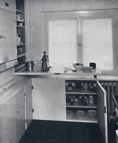 'Werner Harting - Kitchen with a black Dutch tiled floor, white walls and built-in shelves and cupbo Artist: Unknown.