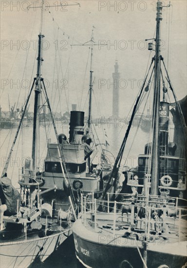 'Naval Trawler, HMS Liffy alongside a Grimsby fishing vessel in Grimsby Docks', 1937. Artist: Unknown.